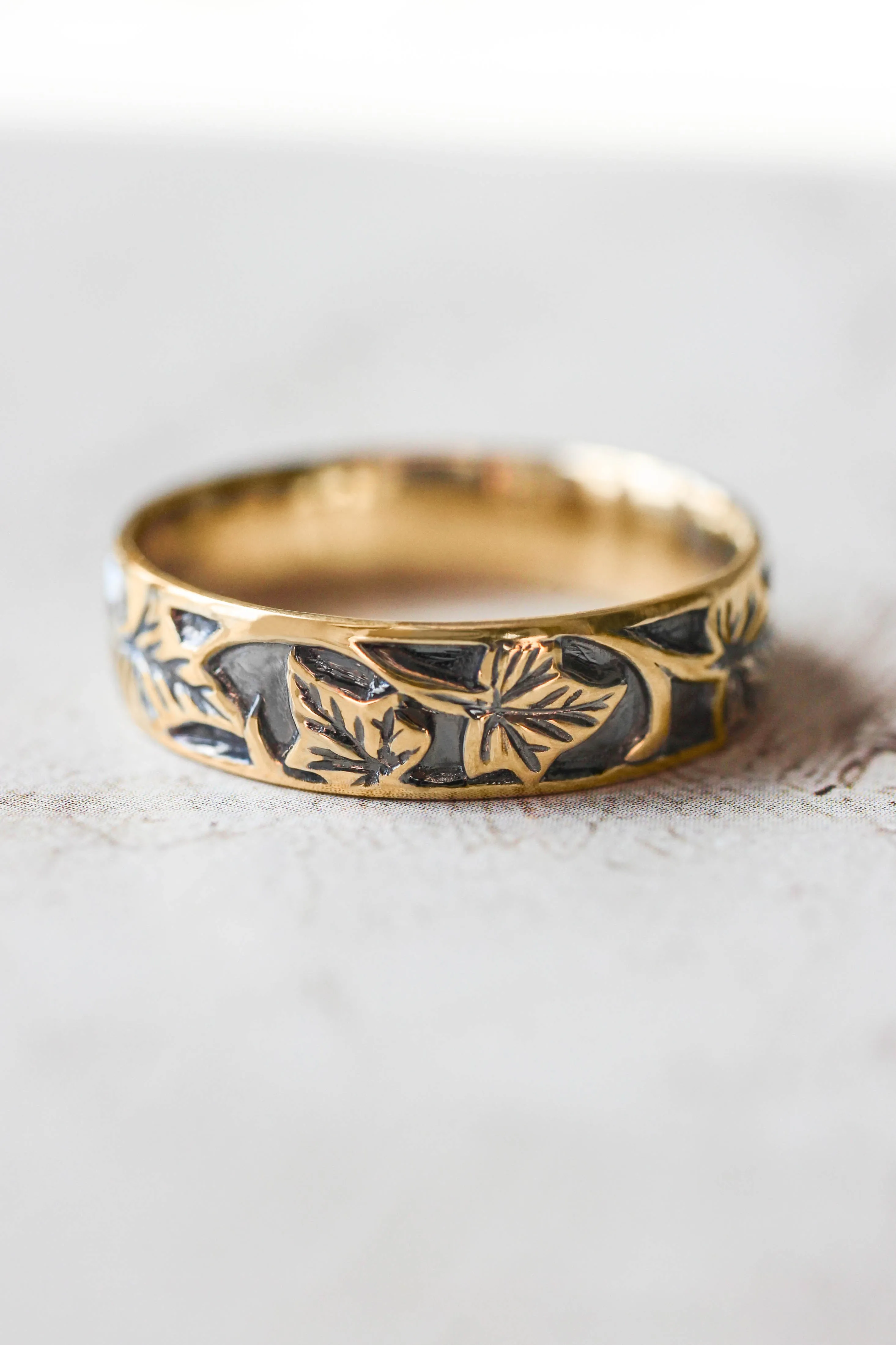 Wedding rings set for couples: black and gold ivy leaves band for him, ivy leaves band with sapphire and diamonds for her