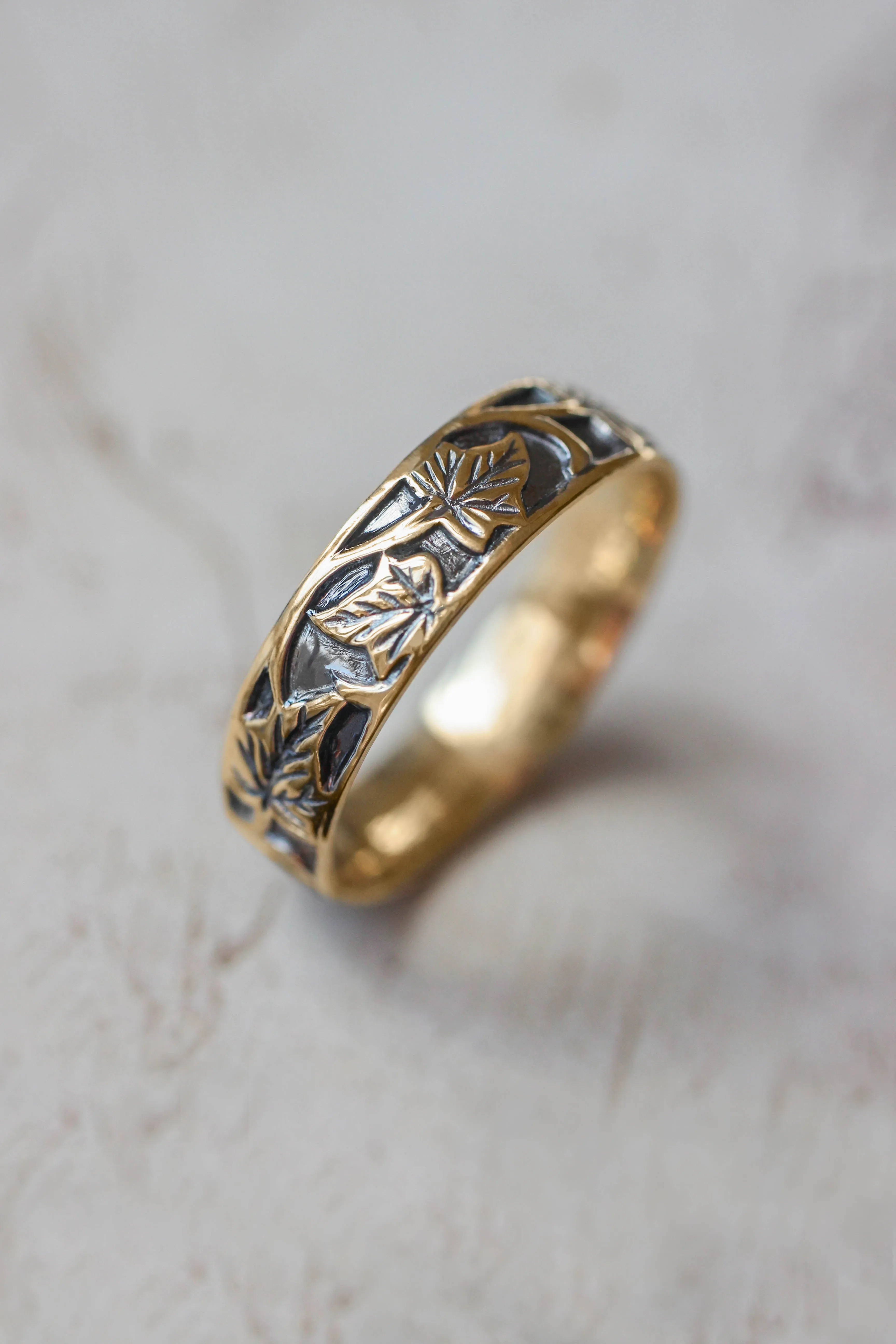 Wedding rings set for couples: black and gold ivy leaves band for him, ivy leaves band with sapphire and diamonds for her