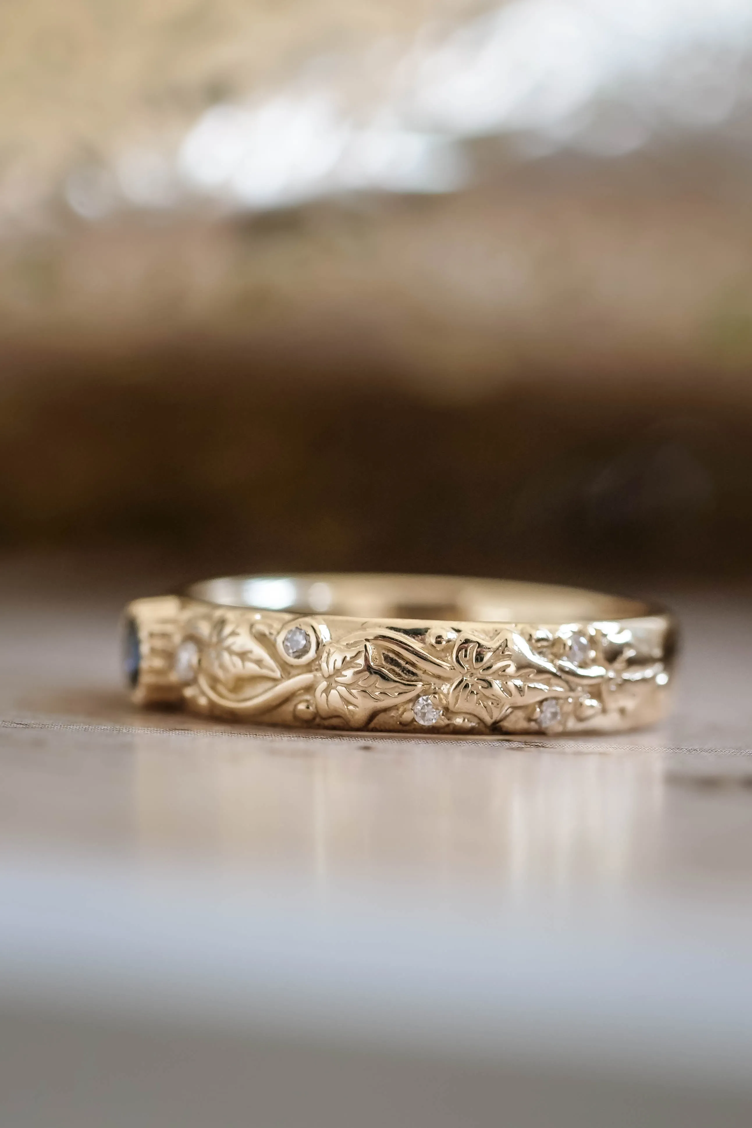 Wedding rings set for couples: black and gold ivy leaves band for him, ivy leaves band with sapphire and diamonds for her